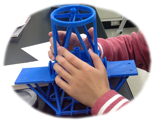 A student is touching the Subaru Telescope model.